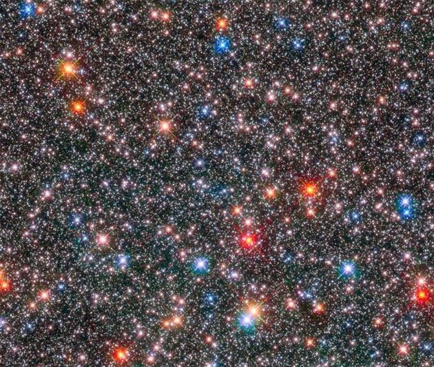 图中是哈勃太空望远镜观测的银河系中心膨胀区域。许多昏暗模糊的恒星是类似太阳的恒星，基于其化学成分不同，它们以不同速度环绕银河系中心膨胀区域运行。